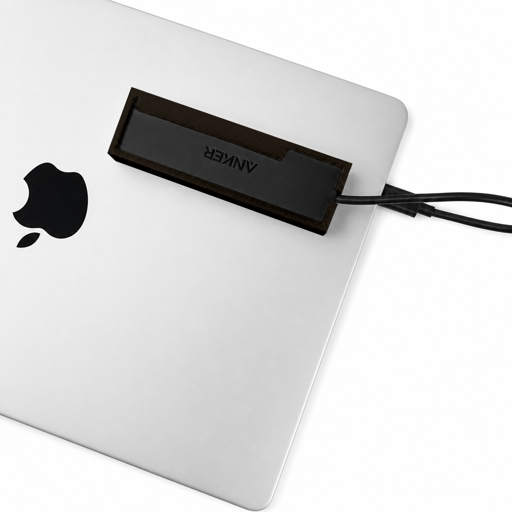 Top view of a black HubMount mounted on a closed MacBook lid.