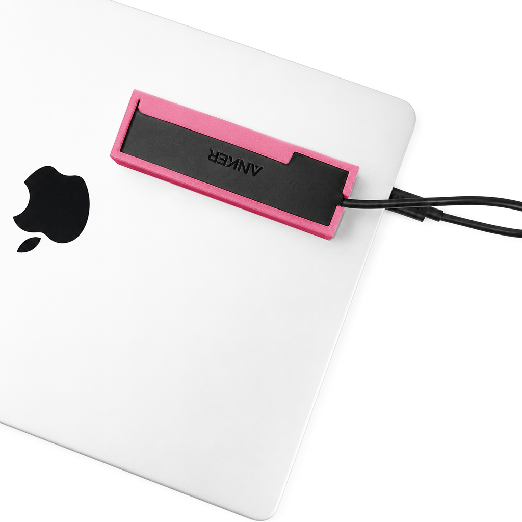 Top view of a light pink HubMount mounted on a closed MacBook lid.