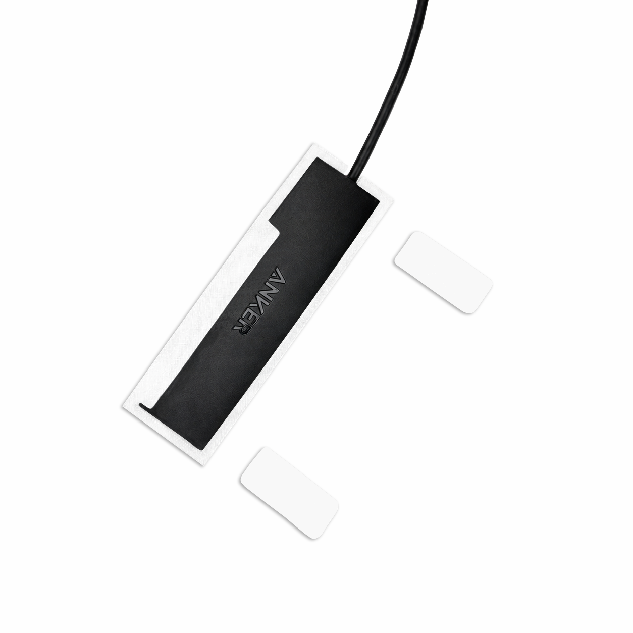 Top view of white HubMount magnetic case holding an Anker USB hub, with adhesive magnetic feet positioned beside it.