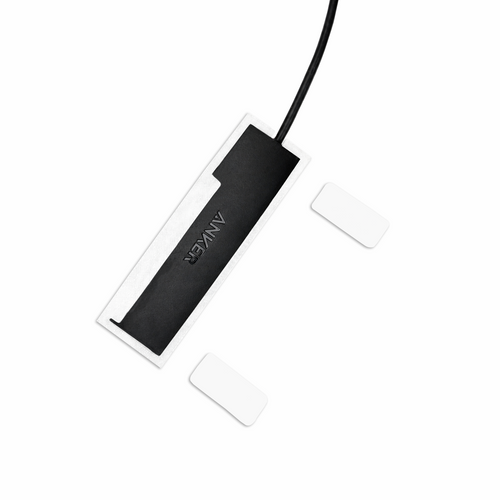 Top view of white HubMount magnetic case holding an Anker USB hub, with adhesive magnetic feet positioned beside it.