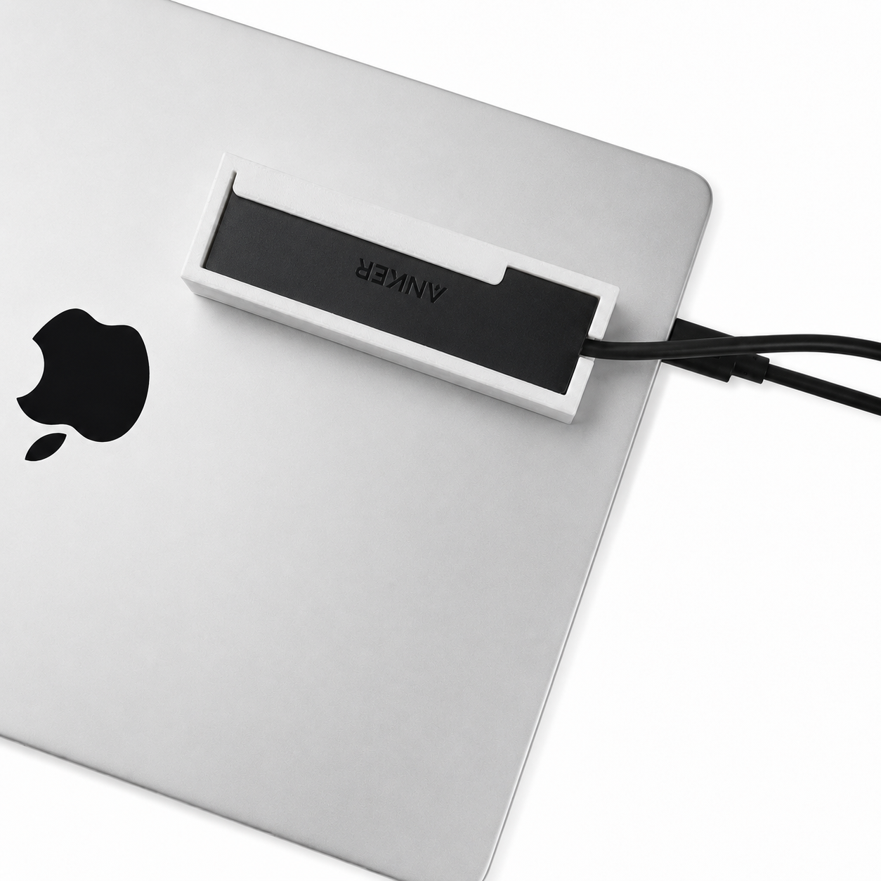 Top view of a white HubMount mounted on a closed MacBook lid.